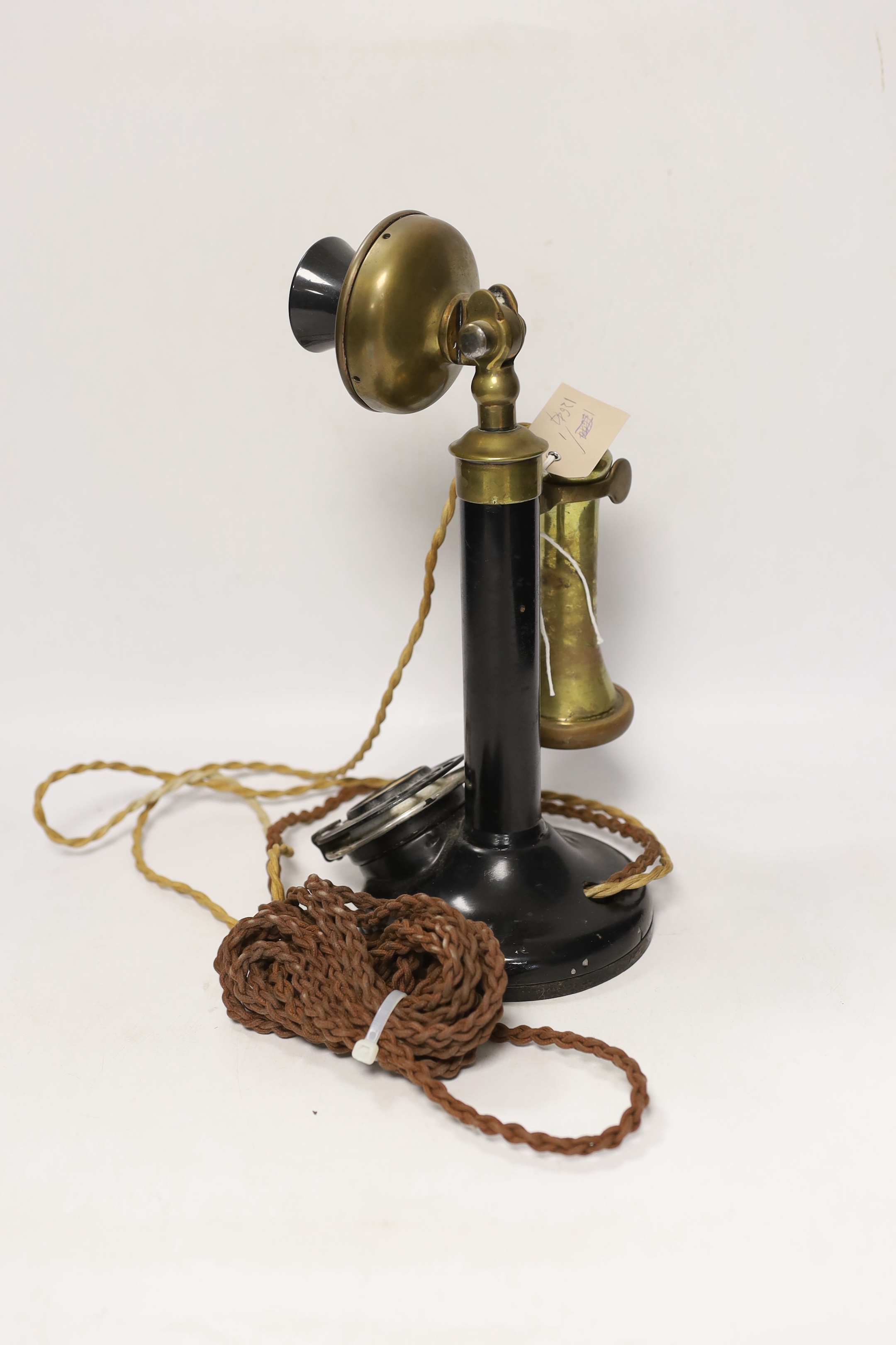 A vintage stick telephone, 32cm high